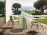 The Bolle little armchair together with the Plissè table in an outdoor area