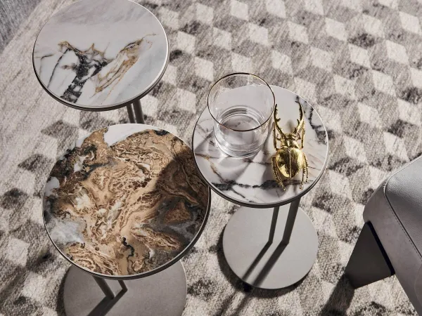 A set of three Sting side tables with marble top