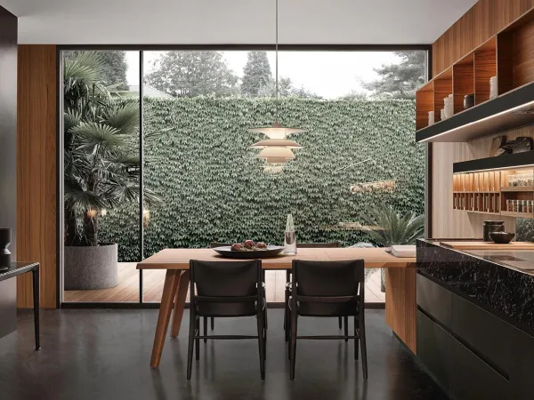 La cocina Convivium con la mesa península en un comedor