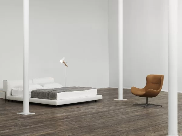 The Oolong armchair by Living Divani in a bedroom