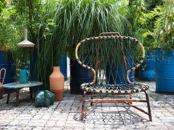 Baxter Manila armchair in an outdoor space